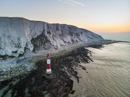 Aerial drone landscape image of lighthouse and chalk cliffs at sunrise in Englandの素材 [FY310121376435]