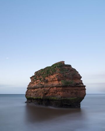 Beautiful sunrise landscape image of Ladram Bay beach in Devon England with stunning rock stacks on beachの写真素材