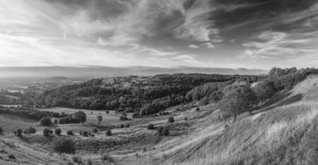 Beautiful  black and white landscape image of view over English countryside during Summer sunset