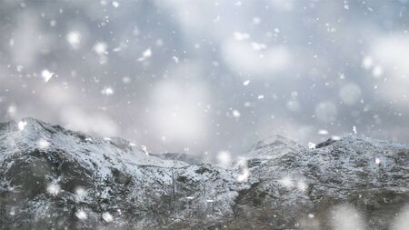 Beautiful landscape image in Winter of Snowdonia National Park with snow capped mountains in background in heavy snow stormの写真素材