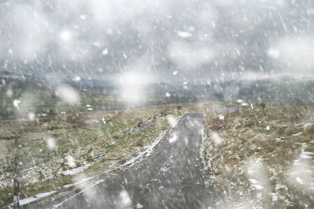 Peak District landscape duruing Winter with snow on ground looking from countryside towards Hope...