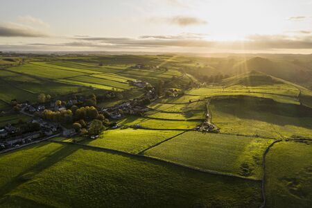 Beautiful aerial drone landscape image of Peak District countryside at sunrise on Autumn Fall...