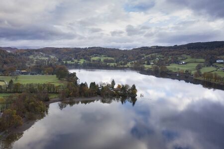 Stunning aerial drone landscape images over Coniston Water at sunrise on beautiful Autumn Fall morningの写真素材