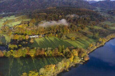 Stunning aerial drone landscape images over Coniston Water at sunrise on beautiful Autumn Fall morningの写真素材