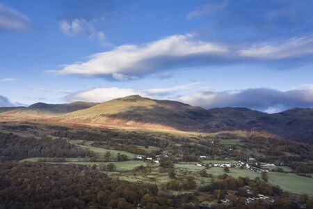Stunning aerial drone landscape image from in the clouds looking down on hills and valleys on a...