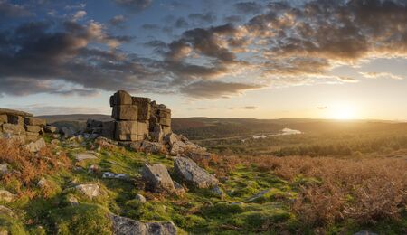 Epic sunset over landscape of Leather Tor in Dartmoor during Summer with dramatic skyの写真素材