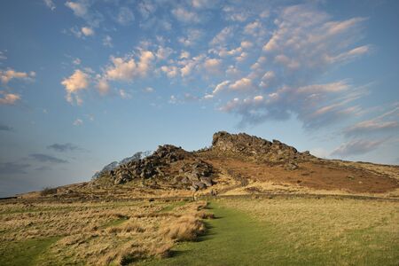 Stunning Peak District Winter landscape of Ramsaw Rocks viewed from Hen Cloud with beautiful sunset...