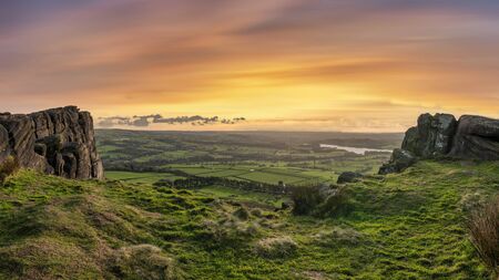 Stunning Peak District Winter landscape of view from top of Hen Cloud over countryside and towards...