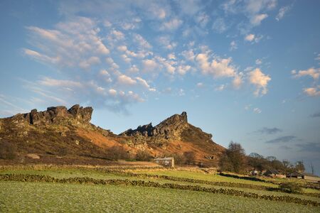 Stunning Peak District Winter landscape of view from The Roaches out across the frozen countryside