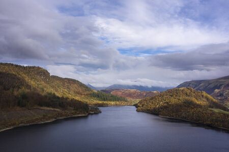 Beautiful aerial drone landscape image of glorious Autumn Fall sun over Thirlmere in Lake District