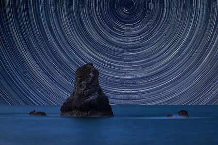 Digital composite image of star trails around Polaris with Beautiful long exposure peaceful...