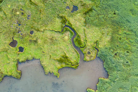 Drone top down bird's eye view landscape image of tidal wetlands in Christchurch Harbour on...