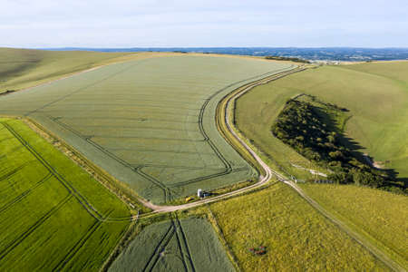 Beautiful high flying drone landscape image of rolling hills in English countryside with lovely warm...