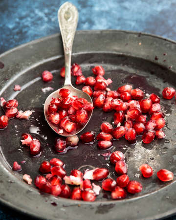 Beautiful food portrait of pulled Pomegranate and seeds with vintage texture backgroundの写真素材