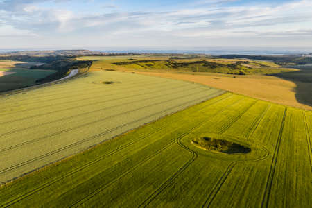 Beautiful high flying drone landscape image of rolling hills in English countryside with lovely warm...