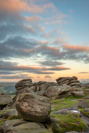 Stunning landscape view of late Summer heather in Peak District around Higger Tor at sunrise