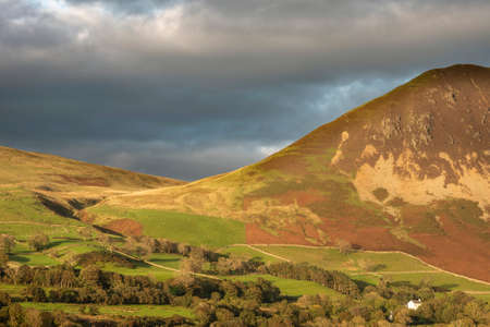 Wonderful landscape image in the English Lake District glorious Summer sunset light dappled acros the hillsの写真素材