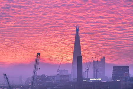 Epic sunrise over London city skyline with stunning sky formations over iconic landmarksの写真素材