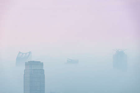 Stunning sunrise landscape image of fog above London city landmarks with besutiful soft light on...