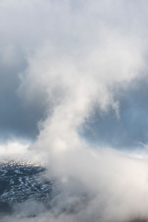 Stunning landscape image of Skiddaw snow capped mountain range in Lake District in Winter with low level cloud around peaksの写真素材