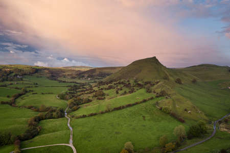 Beautiful aerial drone landscape image of Peak District countryside at sunrise on Autumn Fall...
