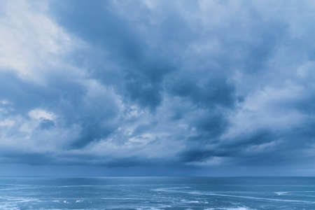 Beautiful fine art landscape image of view from Hartland Quay in Devon England durinbg moody Spring sunsetの写真素材