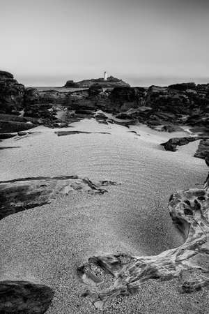 Beautiful and unusual landscape image of Godrevy lighthouse on Cornwall's coastlineの写真素材
