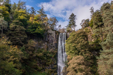 Aerial flying drone Beautiful long exposure landscape early Autumn image of Pistyll Rhaeader waterfall in Walesの写真素材