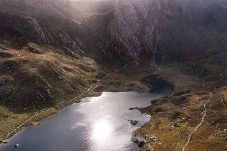 Aerial view of flying drone Epic stunning Autumn landscape image of Llyn Idwal in Devil's Kitchen in Snowdonia National Park with gorgeous lightの写真素材