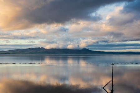 Epic sunset landscape image of Solway Firth viewed from Silloth during stunning Autumn sunset with dramatic sky and cloud formationsの写真素材