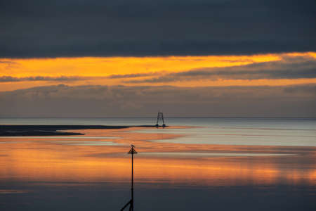 Epic sunset landscape image of Solway Firth viewed from Silloth during stunning Autumn sunset with...