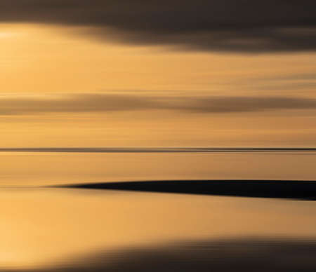 Epic sunset landscape image of Solway Firth viewed from Silloth during stunning Autumn sunset with...