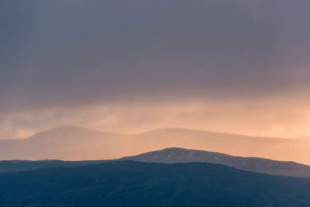 Stunning Winter landscape image of view along Rannoch Moor during heavy rainfall giving misty look to the sceneの写真素材