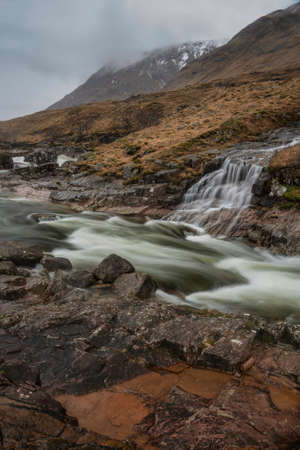 Beautiful Winter landscape image of River Etive and Skyfall Etive Waterfalls in Scottish Highlandsの写真素材