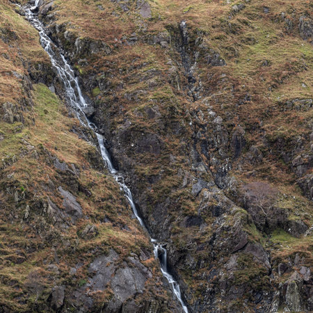 Epic landscape image of mountain stream on the side of Fleetwith Pike Lake District during Autumn sunsetの写真素材