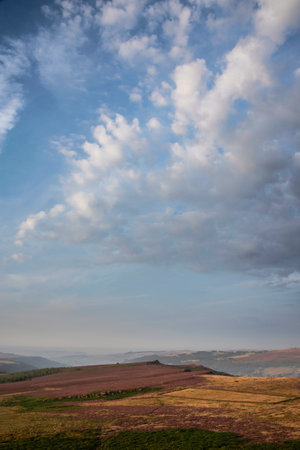 Stunning late Summer sunrise in Peak District over fields of heather in full bloom around Higger Tor and Burbage Edgeの写真素材