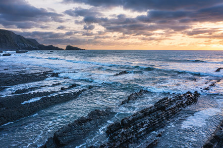 Beautiful aerial drone landscape sunset image of Welcombe Mouth Beach in Devon Englandの写真素材