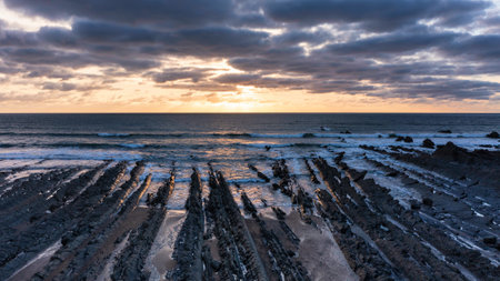 Beautiful aerial drone landscape sunset image of Welcombe Mouth Beach in Devon Englandの写真素材