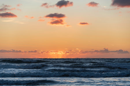 Beautiful Summer sunset landscape image of Widemouth Bay in Devon England with golden hour light on beachの写真素材