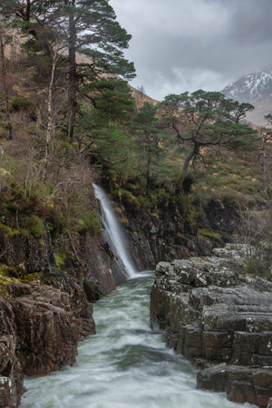 Beautiful Winter landscape image of River Etive and Skyfall Etive Waterfalls in Scottish Highlandsの写真素材