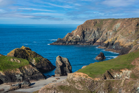 Stunning sunrise over Kynance Cove landscape in Corwnall England with vibrant sky and beautiful...
