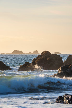 Stunning sunrise over Kynance Cove landscape in Corwnall England with vibrant sky and beautiful turquoise oceanの写真素材