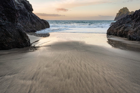 Stunning sunrise over Kynance Cove landscape in Cornwall England with vibrant sky and beautiful turquoise oceanの写真素材