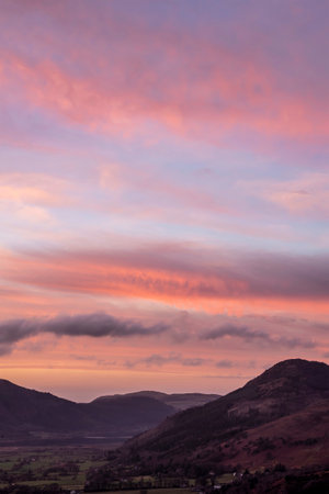 Beautiful Winter sunset landscape over Skiddaw range looking towards Bassenthwaite Lake in Lake Districtの写真素材