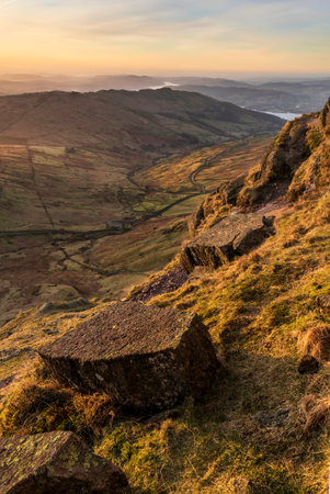 Beautiful Winter dawn landscape view from Red Screes in Lake District looking South towards Windermere with colorful vibrant skyの写真素材