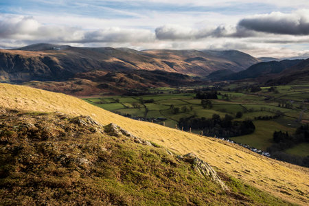 Beautiful early Winter morning landscape view from Latrigg Fell in Lake District across towards Blencathra rangeの写真素材