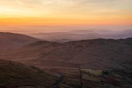 Lovely Winter landscape view from Red Screeds across misty layers of mountains Ill Bell, Stony Cove Pike and Tarn Cragの写真素材
