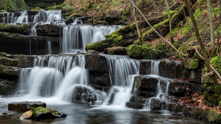 Beautiful peaceful landscape image of Scaleber Force waterfall in Yorkshire Dales in England during Winter morningの写真素材