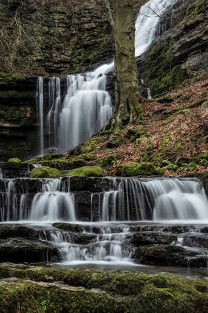 Beautiful peaceful landscape image of Scaleber Force waterfall in Yorkshire Dales in England during Winter morningの写真素材