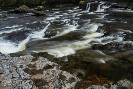 Beautiful peaceful landscape image of Aysgarth Falls in Yorkshire Dales in England during Winter morningの写真素材